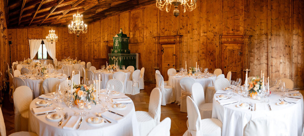 Sala dei cavalieri a Castel Fragsburg allestita con tavoli tondi